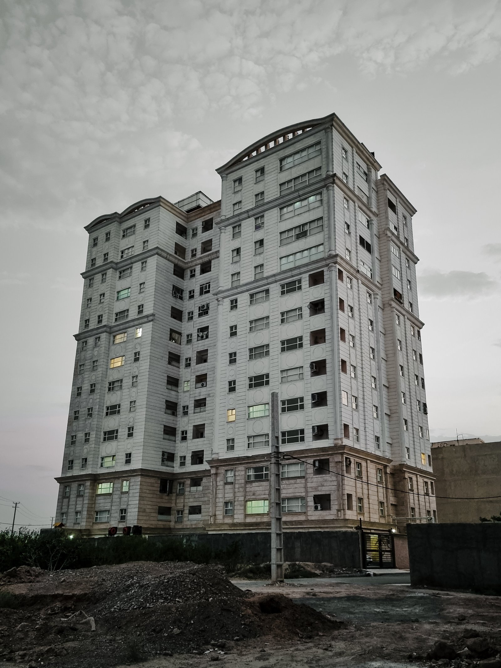 a very tall white building with lots of windows